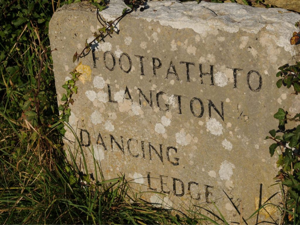 Langton Matravers signpost carved into a stone