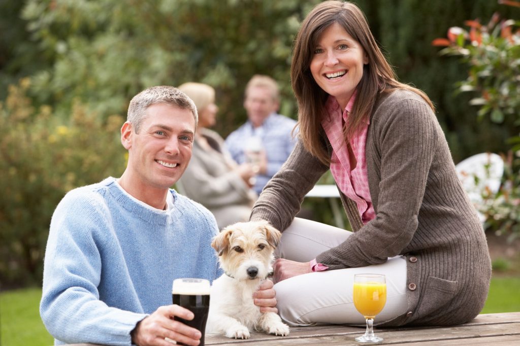 dog with holiday makers at the pub