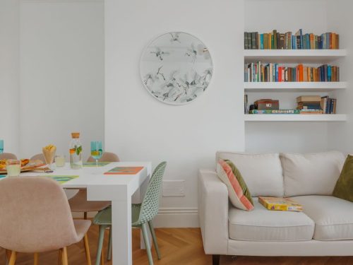 Open-plan living space with sofa and dining table at Beachway House holiday cottage