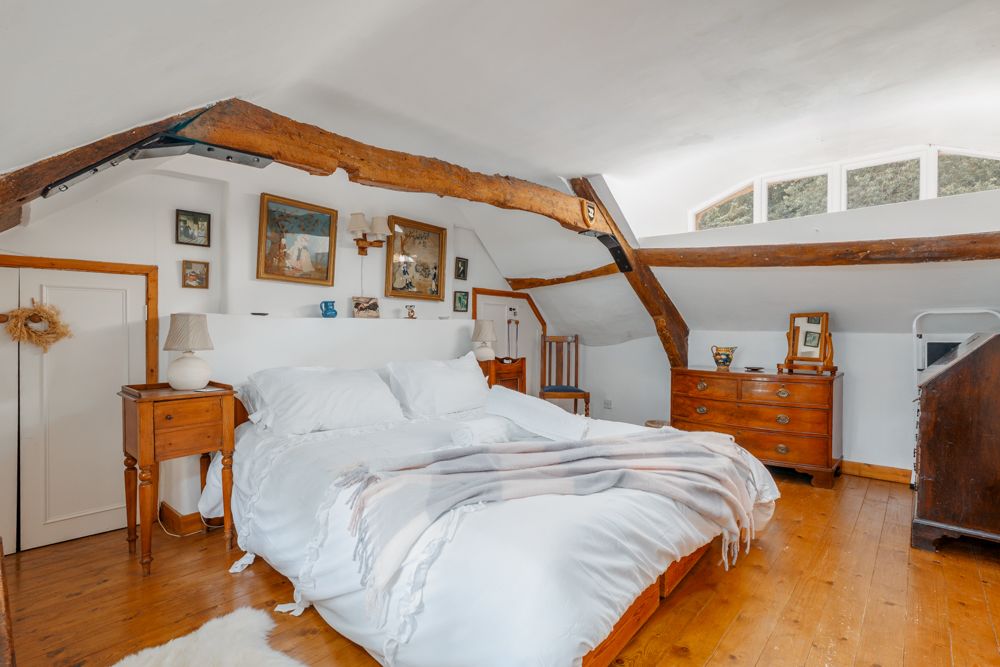 master bedroom in cosy thatched cottage
